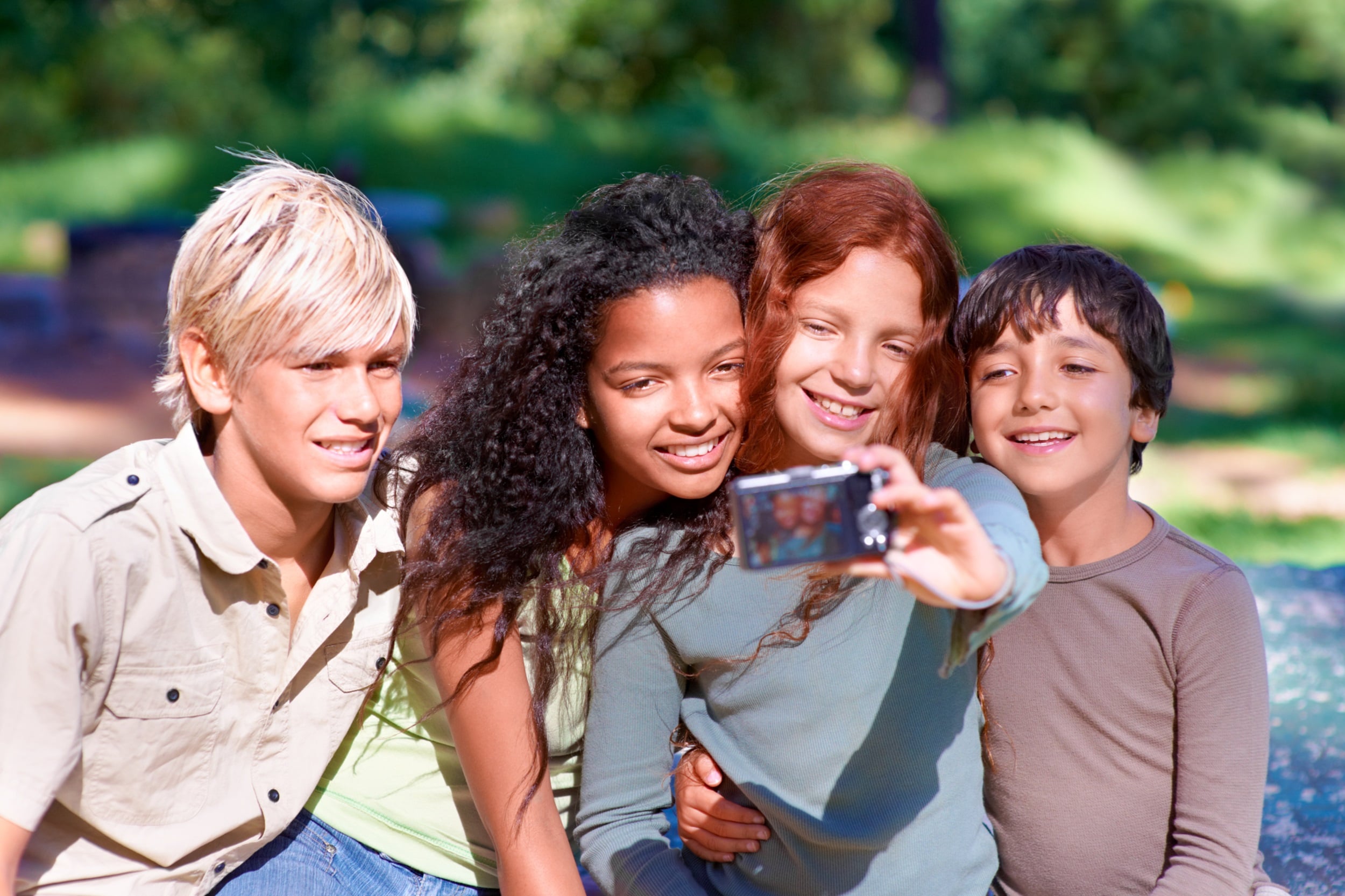 A group of preteens take a selfie.