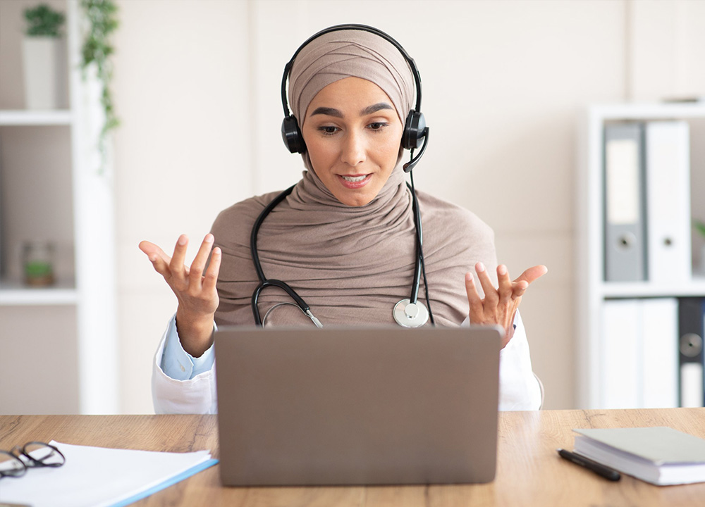 A female doctor takes an online webinar.