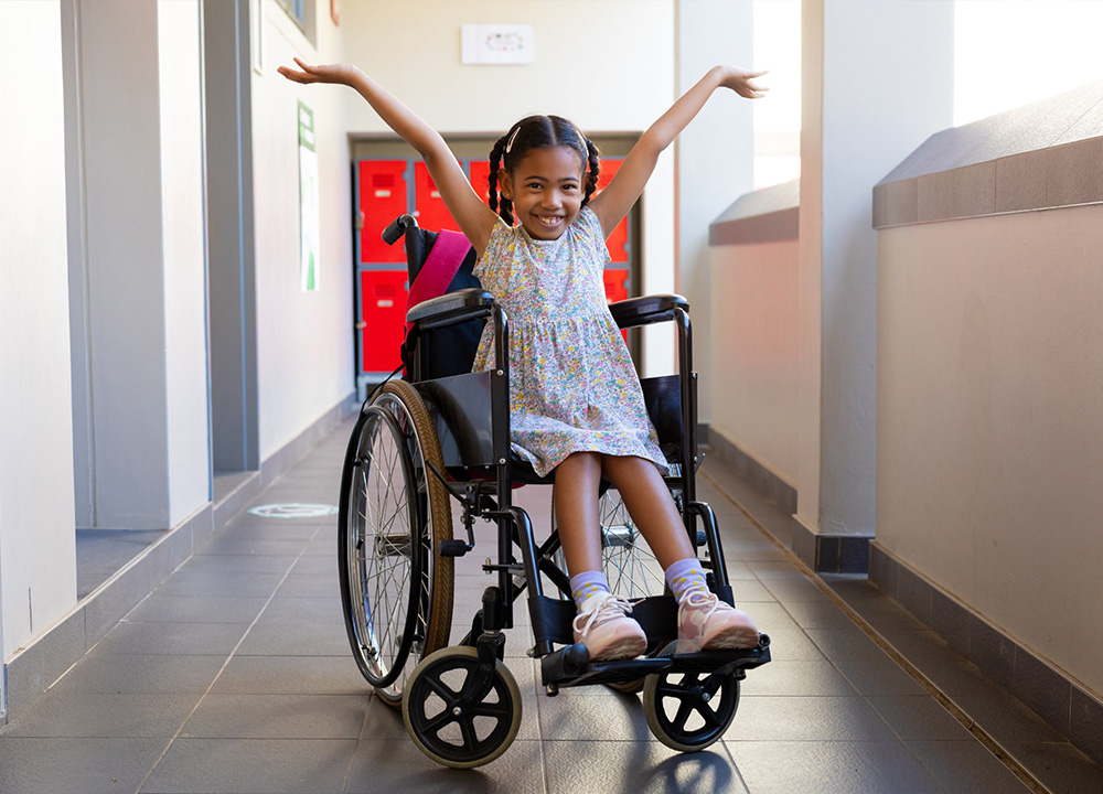 A smiling girl in a wheelchair.