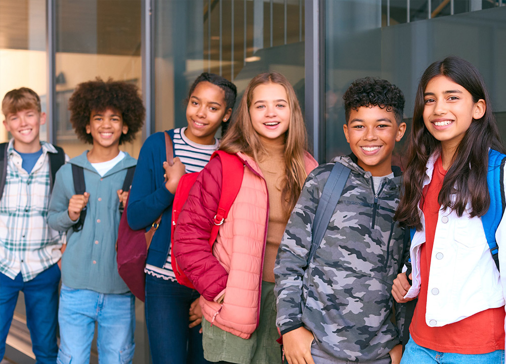 A group of older schoolchildren smiling.