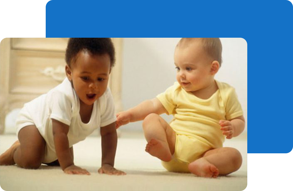 Adorable babies play with each other.