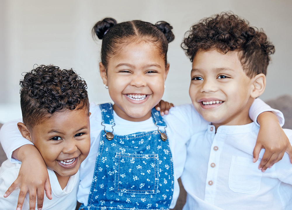 Children who are siblings smiling.