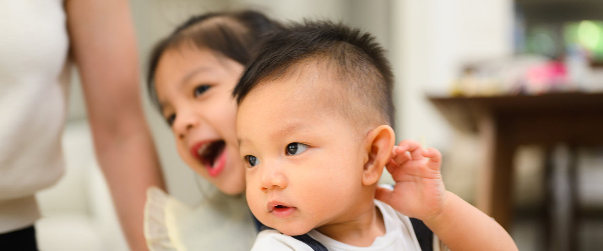 A cute baby looking off in the distance.