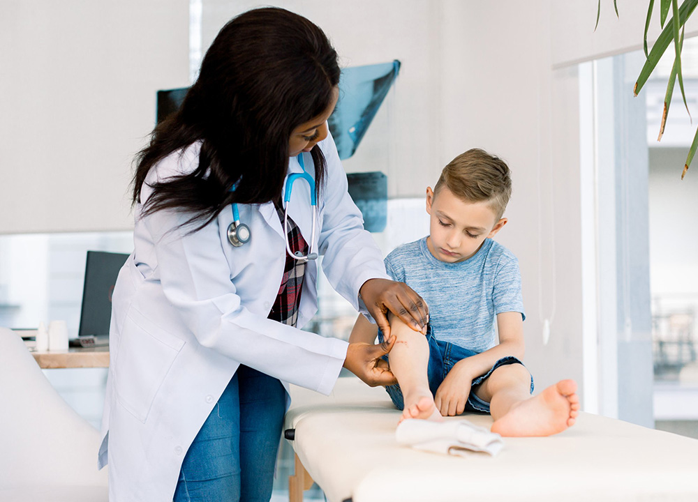 A doctor cares for her child patient.