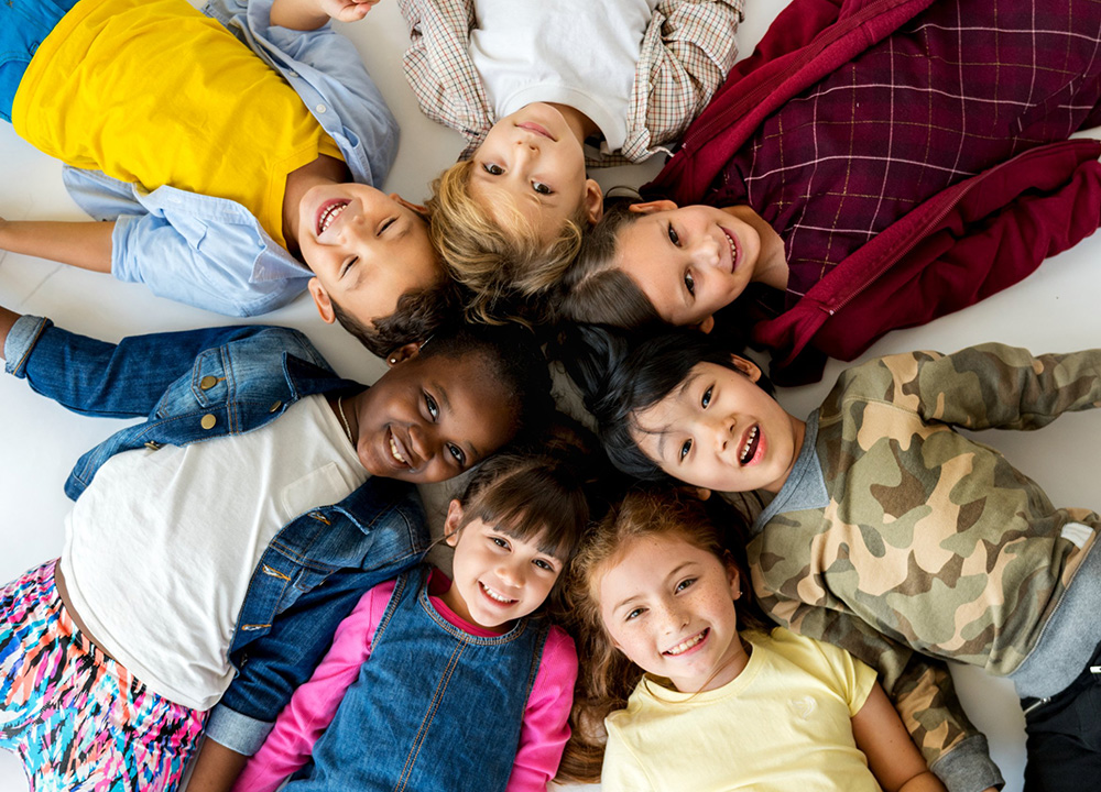 Children laying down in a cicle.