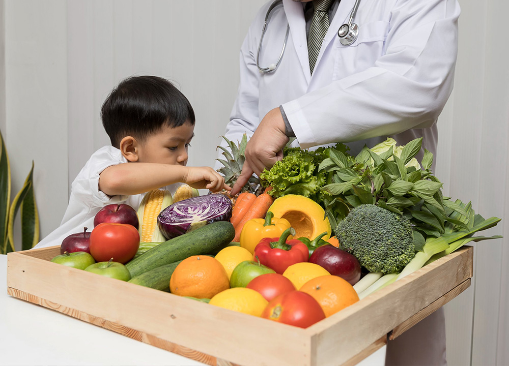 A child examines vegetables provided by a doctor.