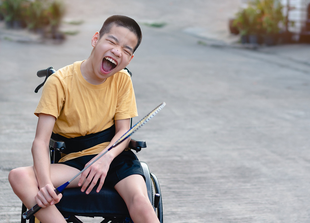 A happy disabled child in a wheelchair.