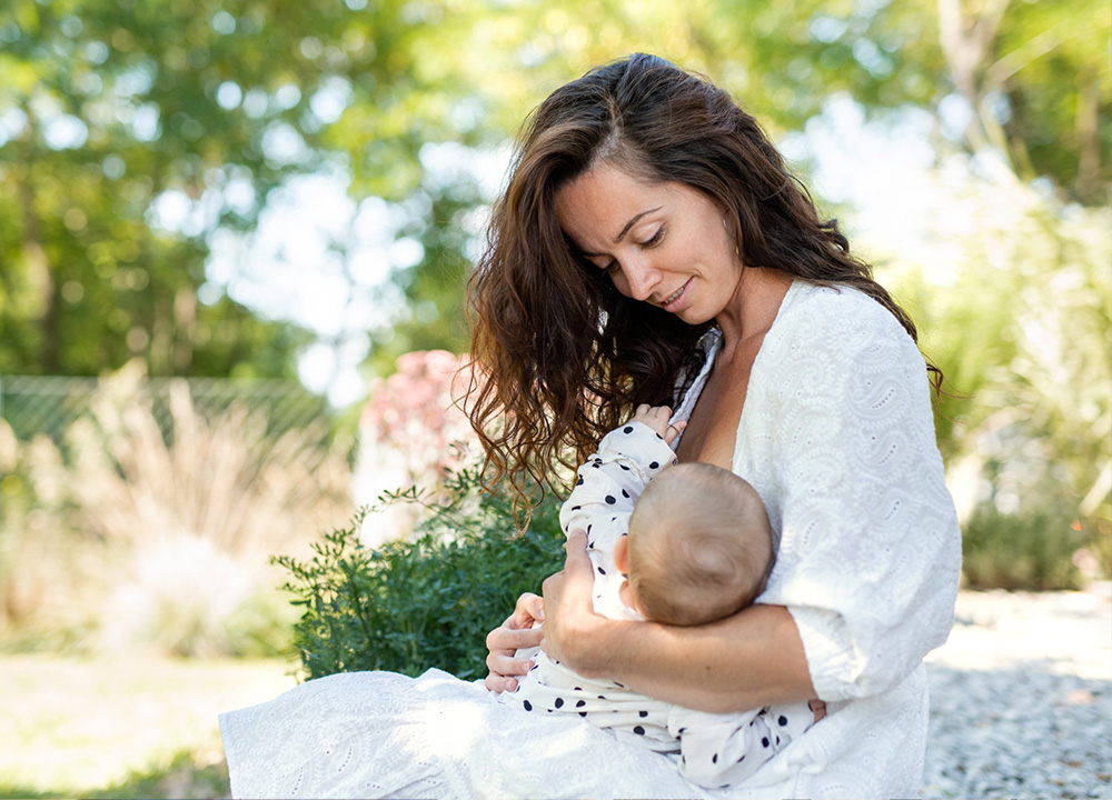 A woman breastfeeding her baby.