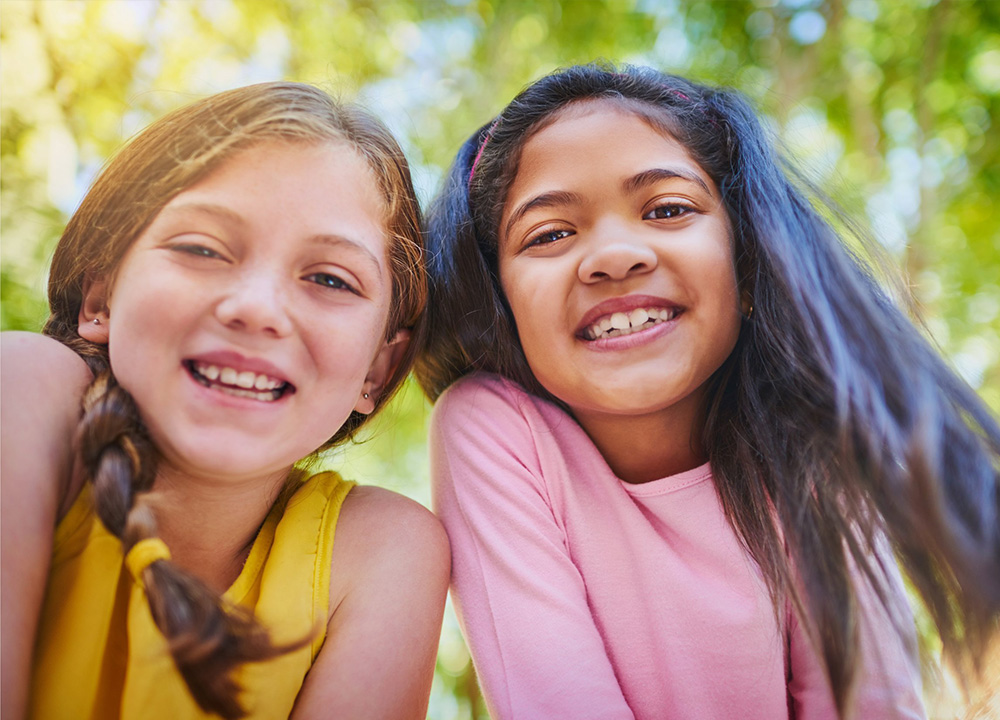 Two girls smiling.