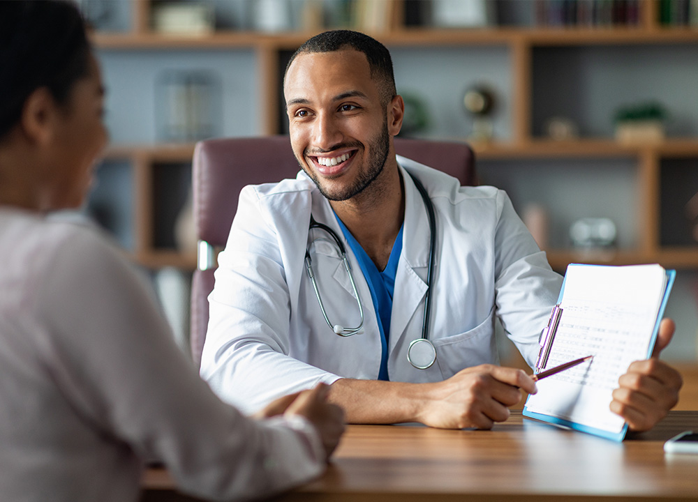 A doctor showing a document to a patient.